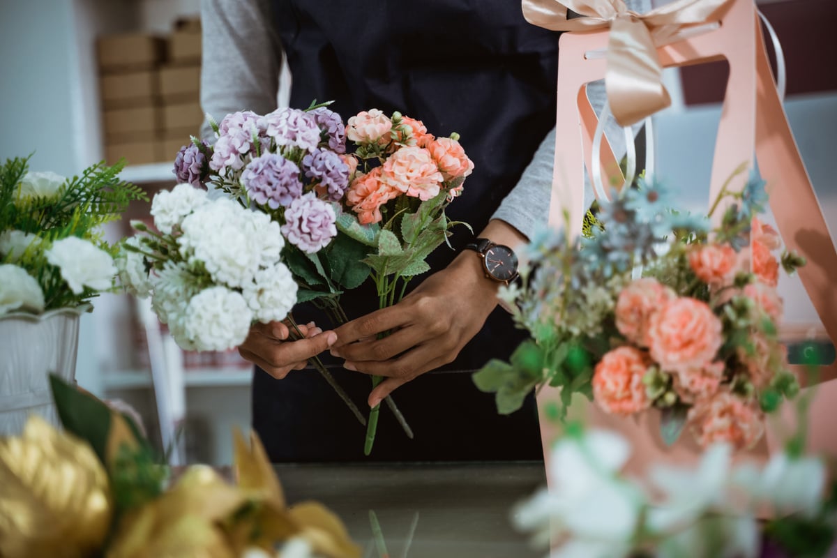 Portrait Florist Preparing a Gift Flower on Table Workspace